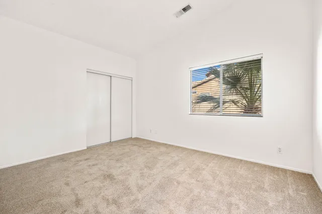 a bedroom with a bed and a potted plant
