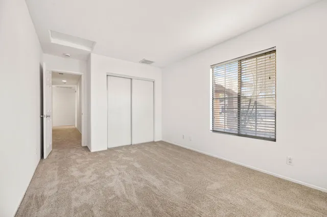 a bedroom with a bed and a television