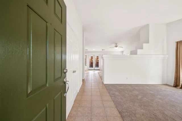 a view of a hallway with wooden shelves