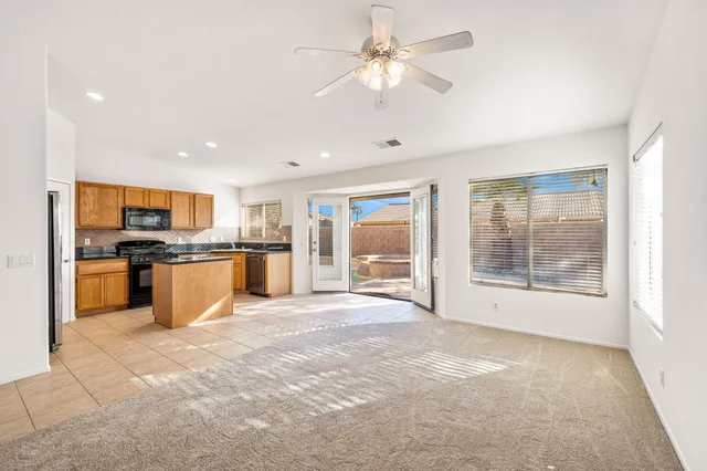 a living room with fireplace furniture and a large window