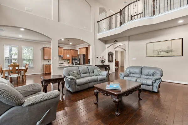 a living room with furniture a rug and a chandelier