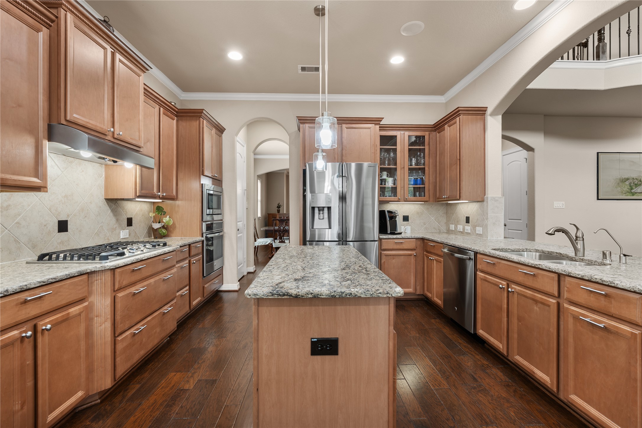 2607 Tree Swallow Bluff Path Spring, TX 77389 - Photo 14 of 44 a large kitchen with stainless steel appliances lots of counter space and wooden floors