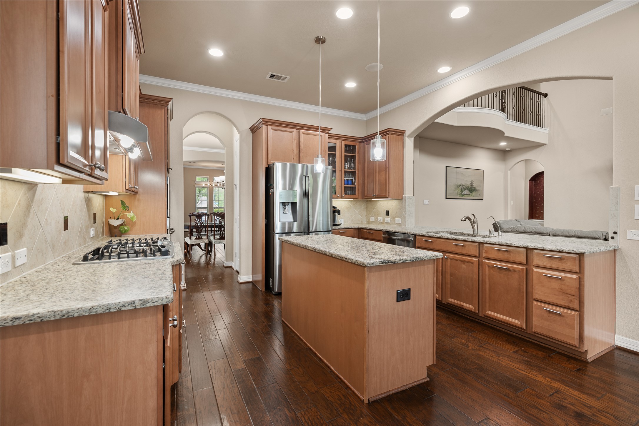 2607 Tree Swallow Bluff Path Spring, TX 77389 - Photo 15 of 44 a large kitchen with stainless steel appliances granite countertop a lot of counter space and wooden floors