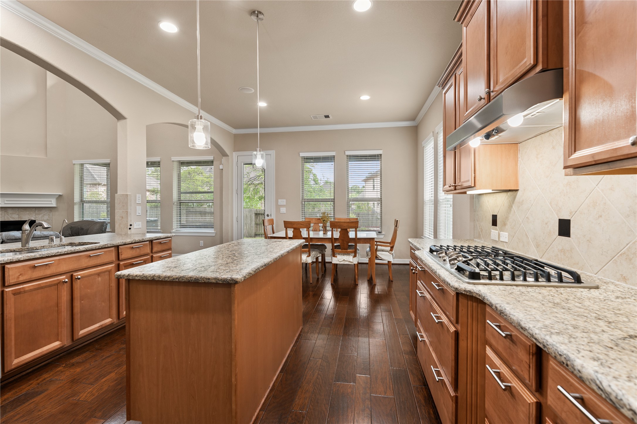 2607 Tree Swallow Bluff Path Spring, TX 77389 - Photo 16 of 44 a large kitchen with kitchen island a large window a sink stainless steel appliances and cabinets