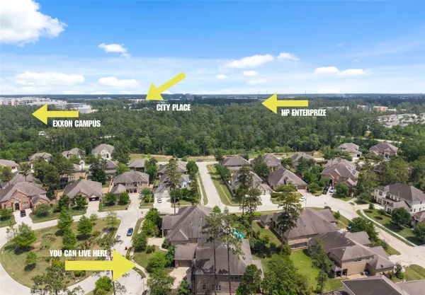 an aerial view of residential houses with outdoor space and ocean view
