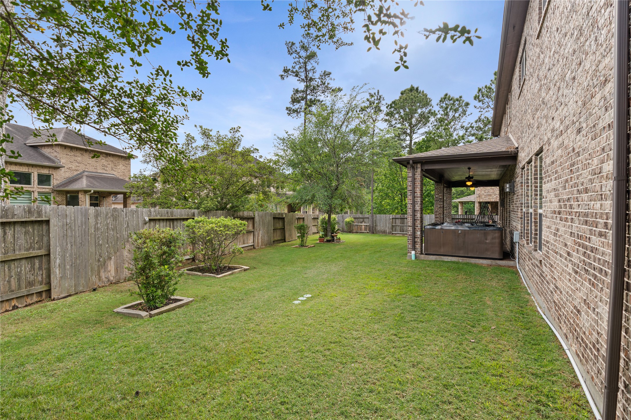 2607 Tree Swallow Bluff Path Spring, TX 77389 - Photo 37 of 44 a view of a backyard with table and chairs and a fire pit