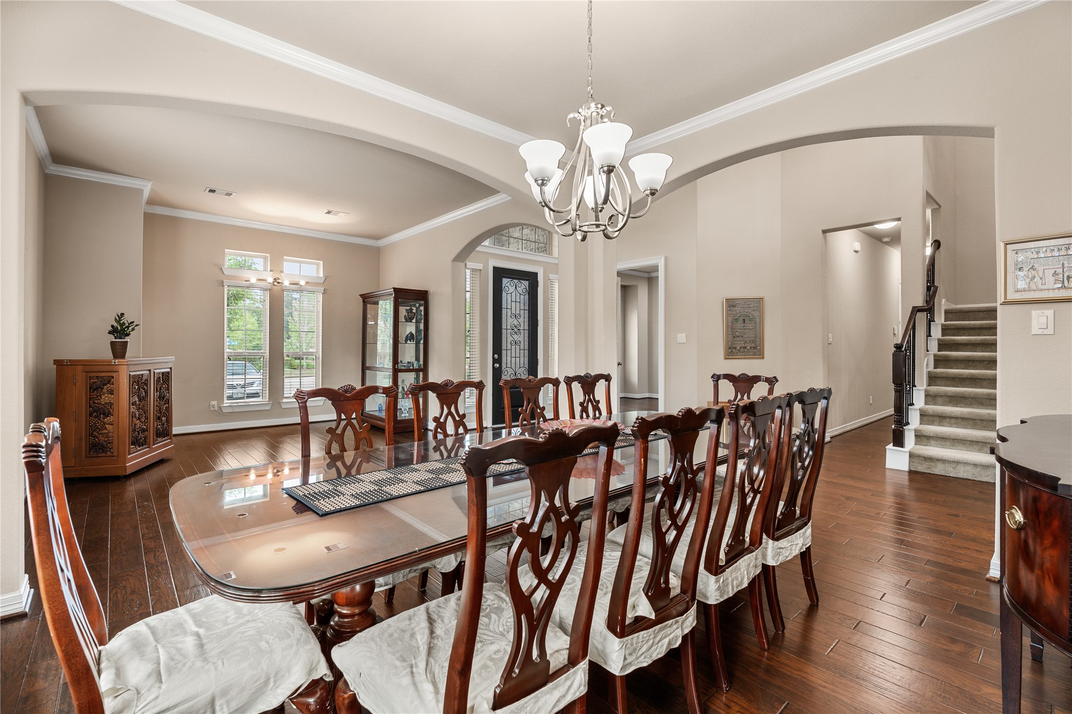 2607 Tree Swallow Bluff Path Spring, TX 77389 - Photo 9 of 44 a view of a dining room with furniture wooden floor and chandelier