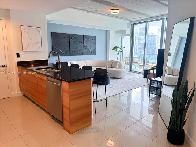 a kitchen with granite countertop a sink a stove and a microwave