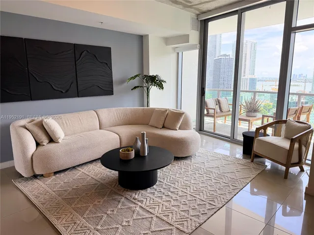 a living room with furniture and a large window