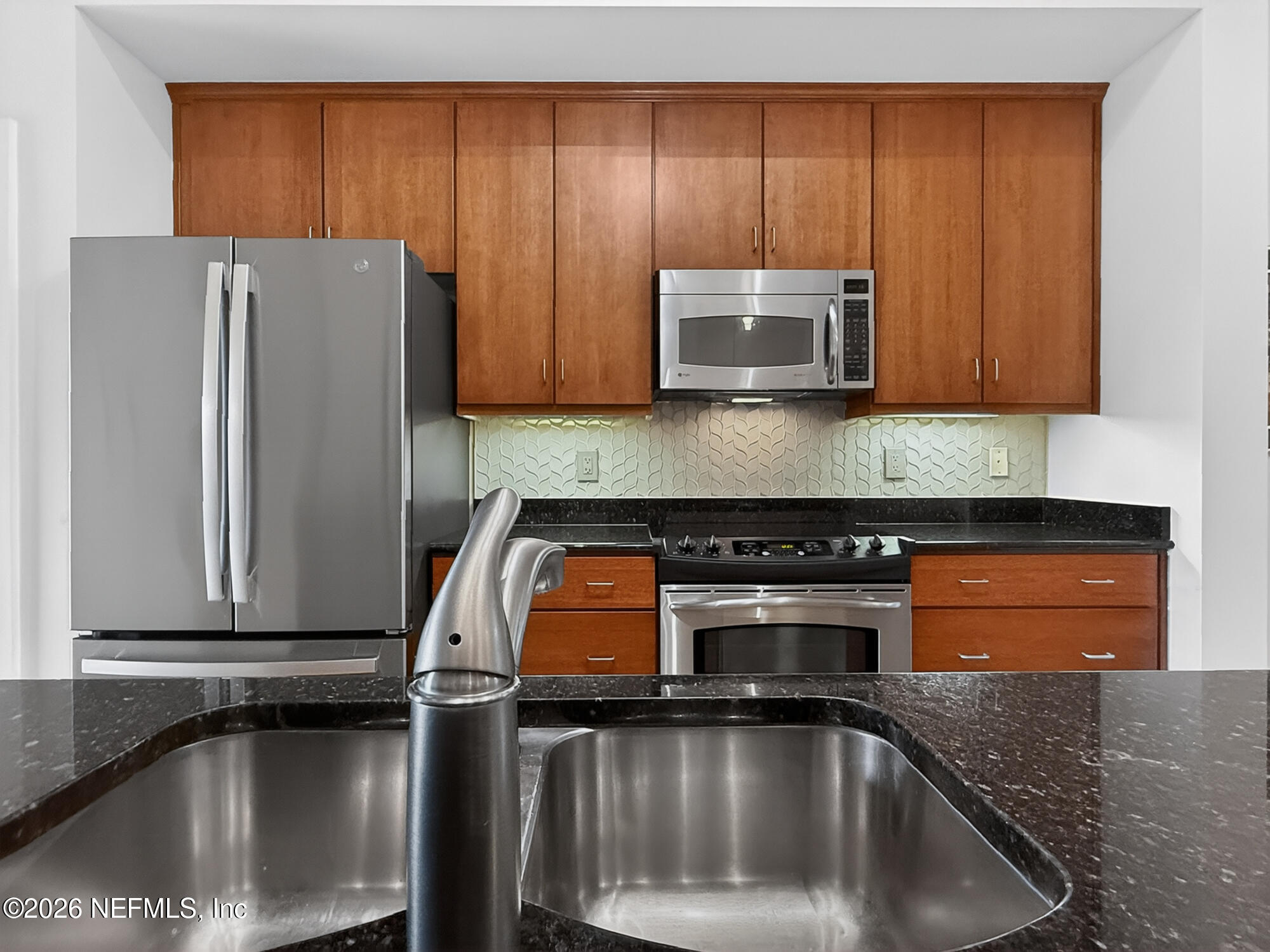 1661 Riverside Avenue, Unit 407 Jacksonville, FL 32204 - Photo 13 of 60 a kitchen with a sink and a refrigerator