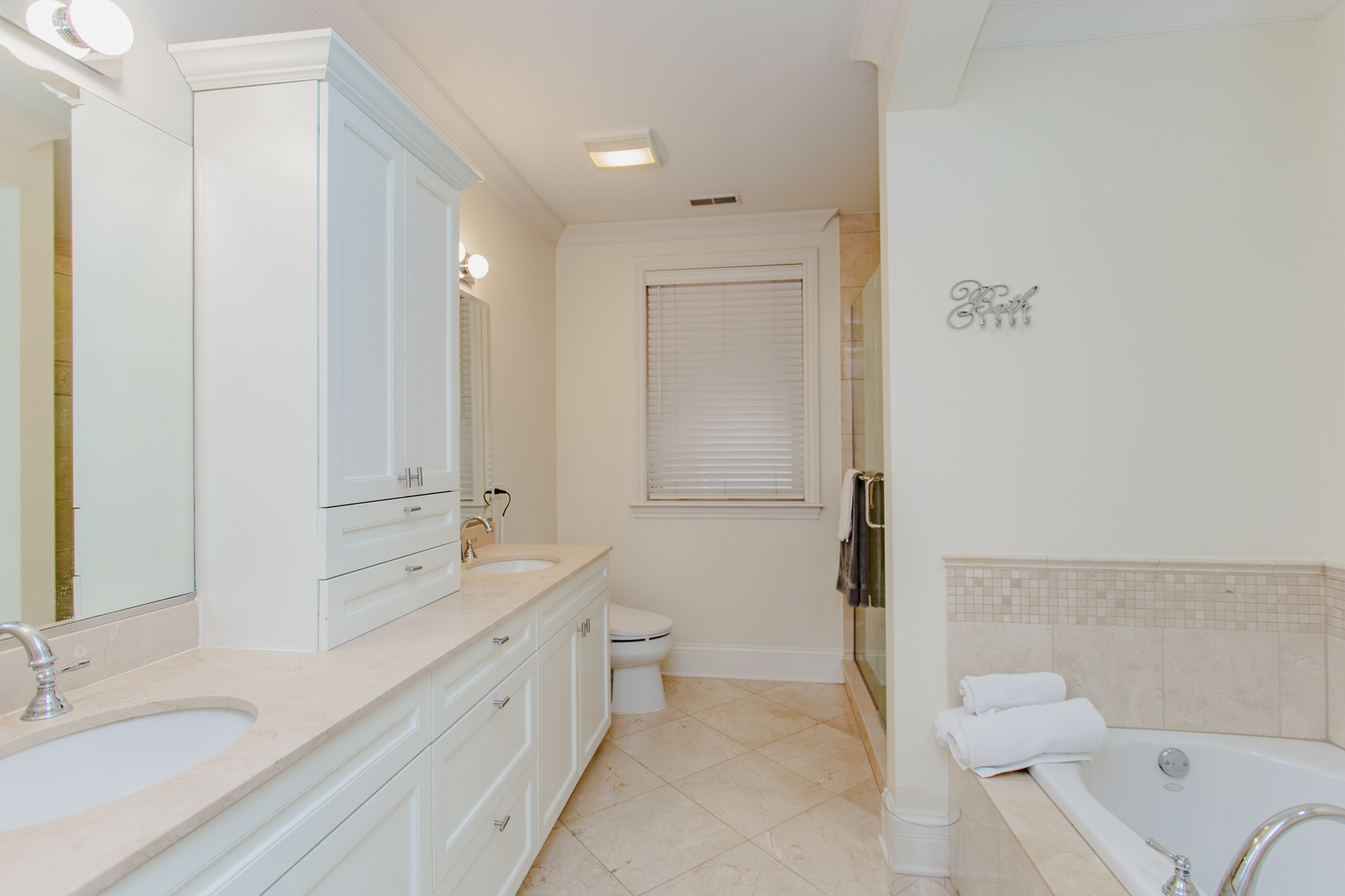 1238 West Jackson Boulevard, Unit 3W Chicago, IL 60607 - Photo 17 of 23 a spacious bathroom with a double vanity sink toilet mirror and bathtub