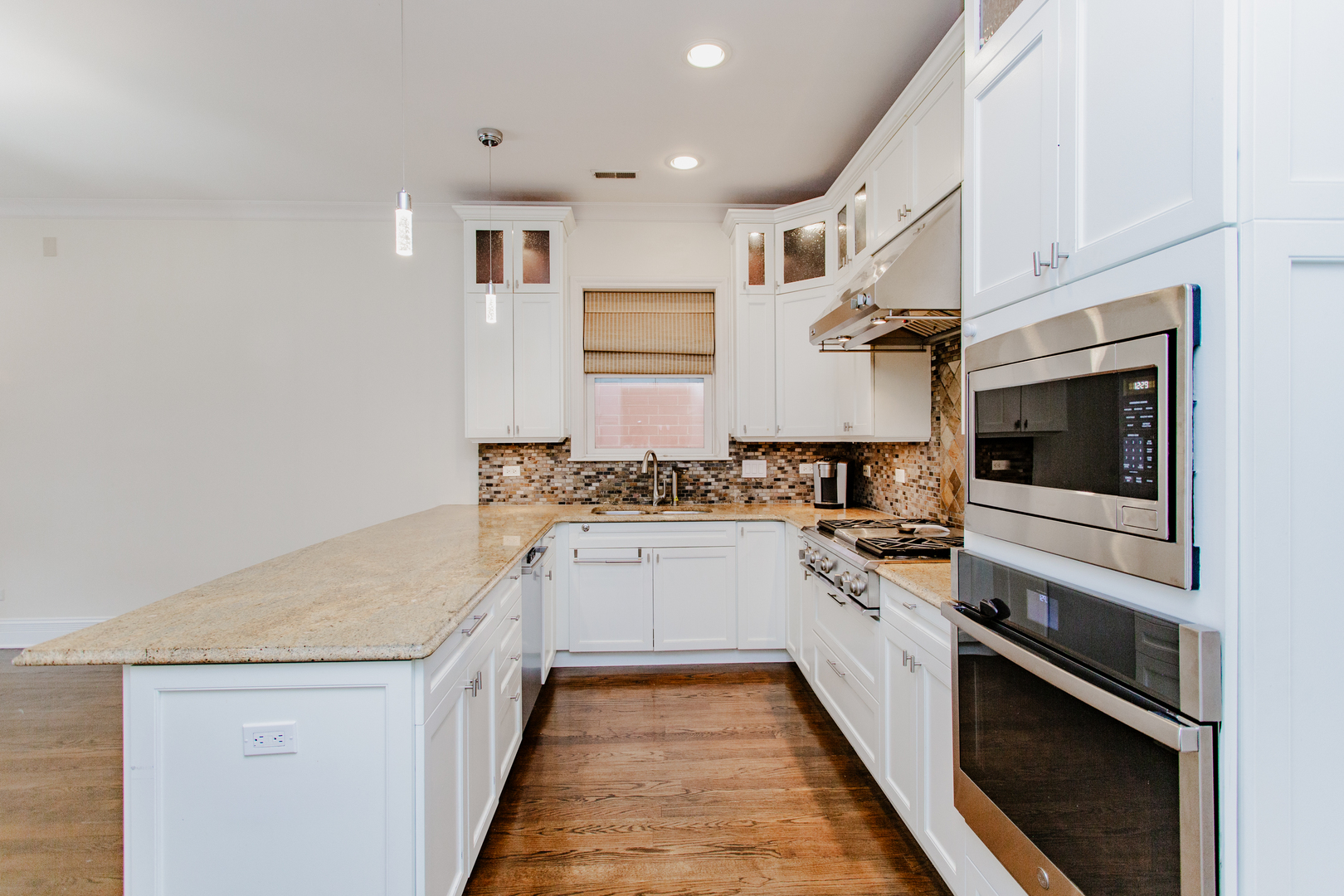 1238 West Jackson Boulevard, Unit 3W Chicago, IL 60607 - Photo 8 of 23 a kitchen with stainless steel appliances granite countertop a stove and a sink