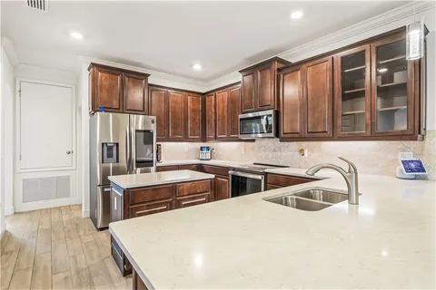 a kitchen with stainless steel appliances granite countertop a sink stove and refrigerator