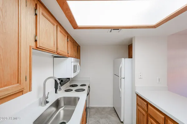 a kitchen with stainless steel appliances a sink a refrigerator and a stove