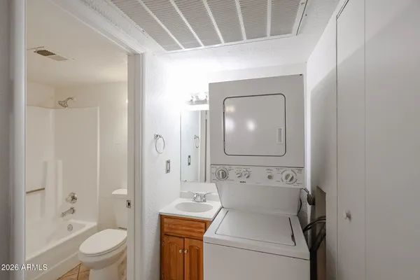 a white toilet sitting next to a white tub