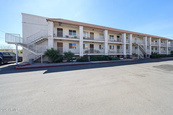 a front view of building with cars parked