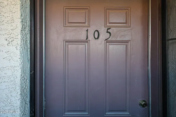 a view of a hallway with wooden door