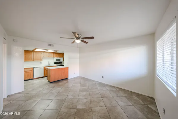 a view of kitchen with stainless steel appliances granite countertop a sink and cabinets