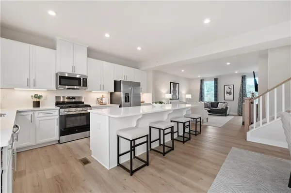 a kitchen with counter space dining table and stainless steel appliances