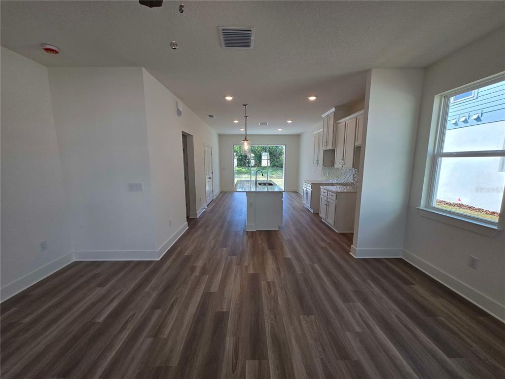 3836 Daybreak Run Loop Spring Hill, FL 34609 - Photo 3 of 13 wooden floor in an empty room with a window