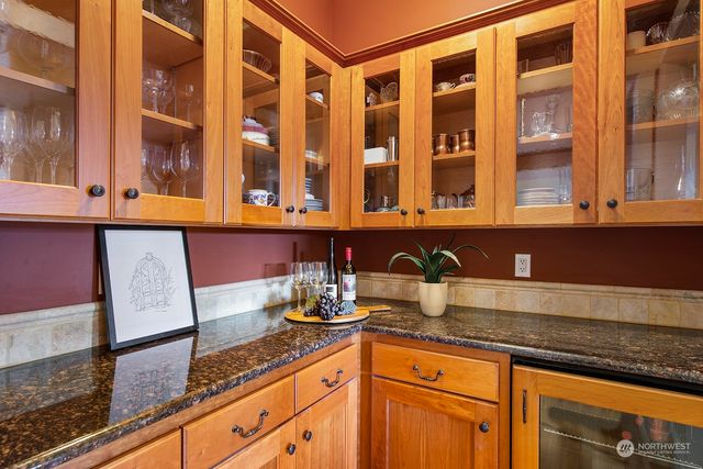 a kitchen with granite countertop stainless steel appliances a sink and cabinets