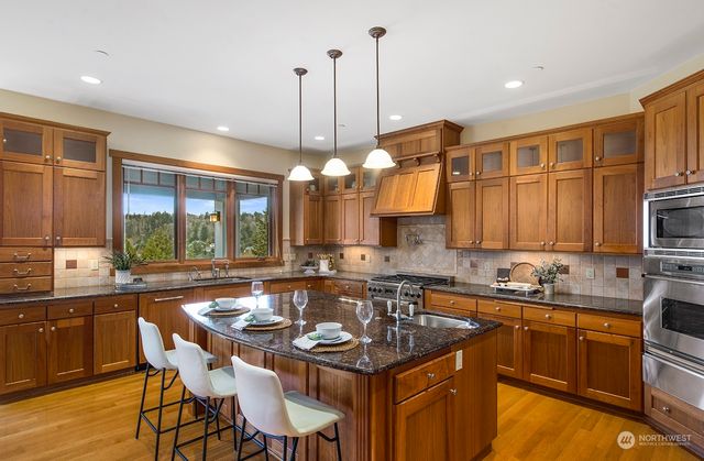 a kitchen with a sink stove and cabinets