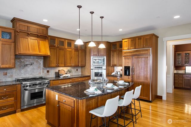 a kitchen with a table chairs stove and refrigerator