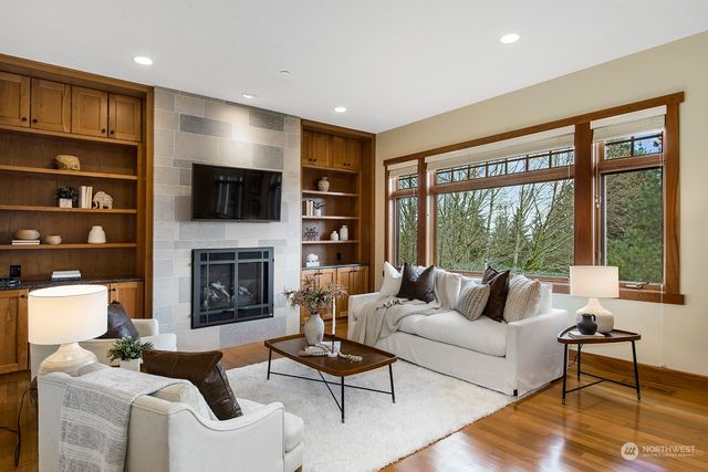 a living room with fireplace furniture and a flat screen tv