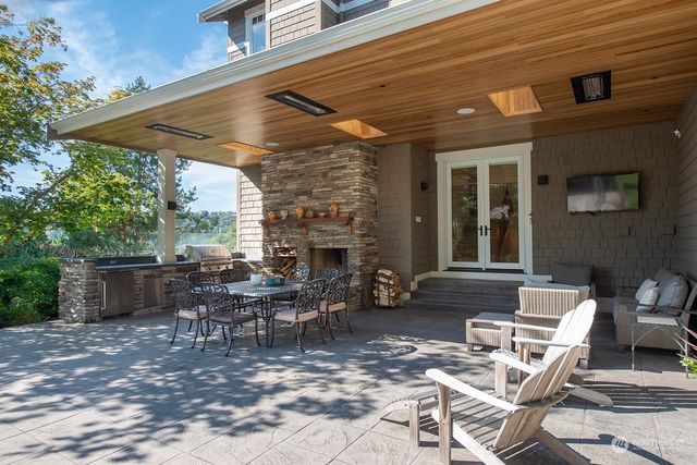 a view of a patio with table and chairs and potted plants