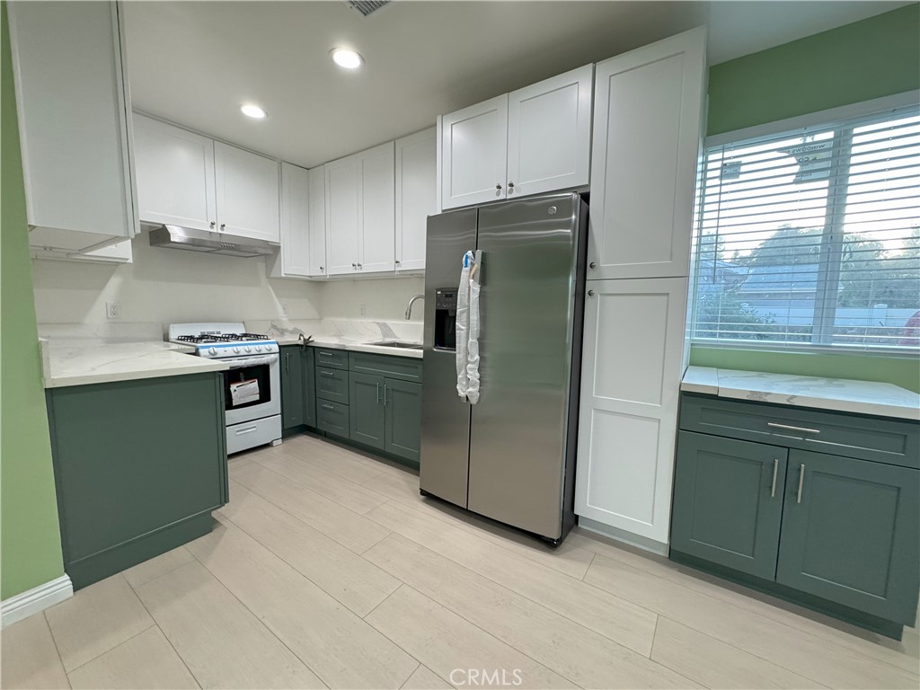 8520 Fenwick Street Sunland, CA 91040 - Photo 12 of 15 a kitchen with stainless steel appliances granite countertop a refrigerator and a sink