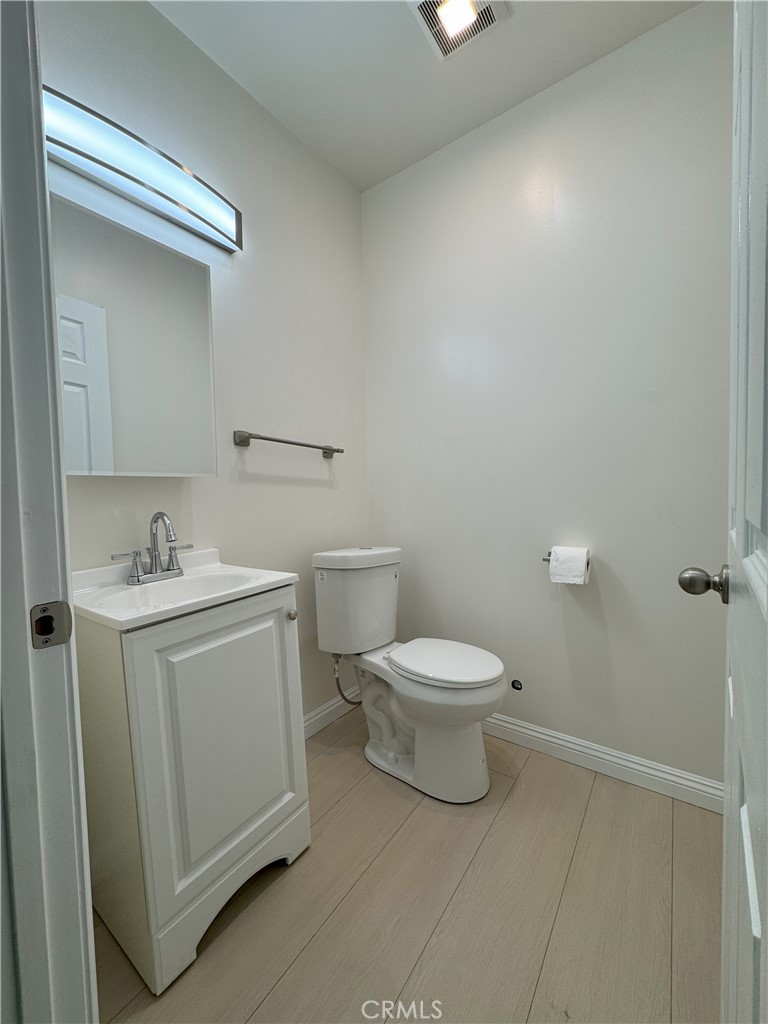 8520 Fenwick Street Sunland, CA 91040 - Photo 8 of 15 a white toilet sitting next to a bathroom sink
