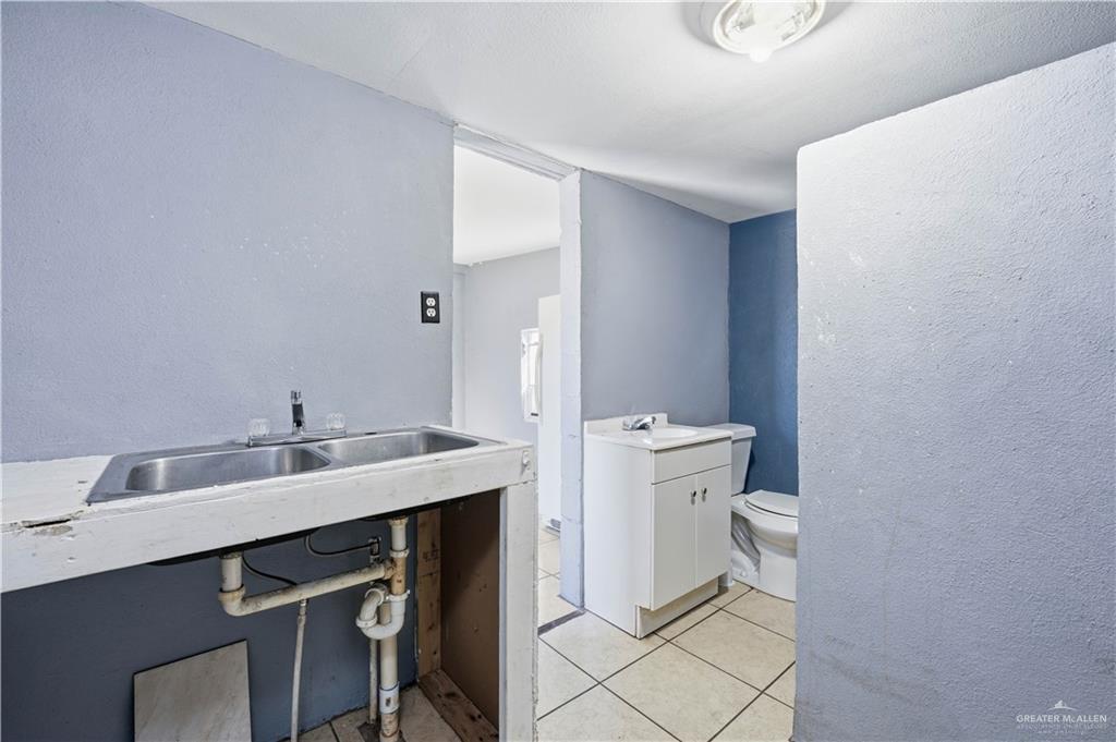 8516 Hendrix Avenue, Unit 2 Edinburg, TX 78542 - Photo 5 of 6 a bathroom with a sink toilet and mirror