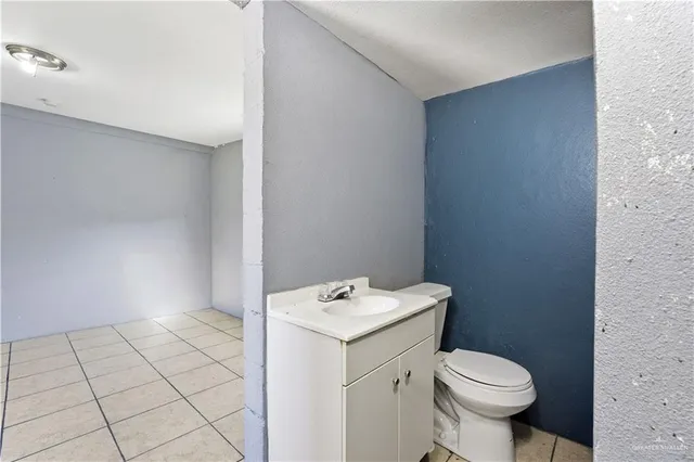 a bathroom with a toilet a sink and a mirror