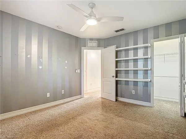 a view of a livingroom with a ceiling fan and window