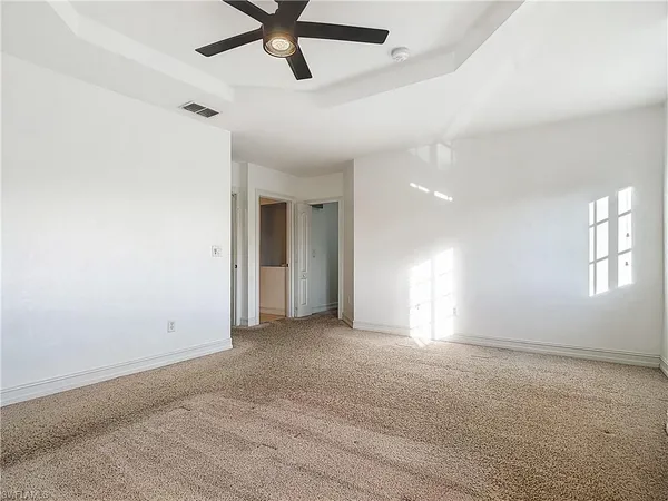 a bathroom with a granite countertop bathtub shower sink vanity and toilet
