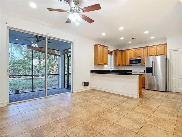 a view of an empty room with a window and chandelier