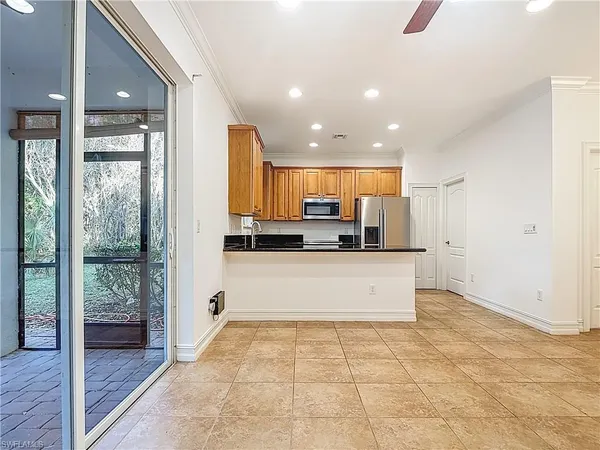 a large kitchen with granite countertop a stove a sink and a refrigerator