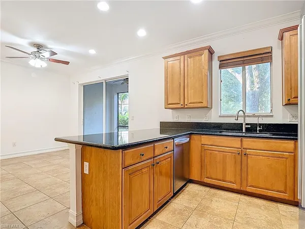 a kitchen with stainless steel appliances granite countertop a sink stove and microwave