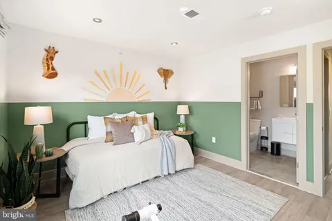 a bedroom with a bed and a lamp