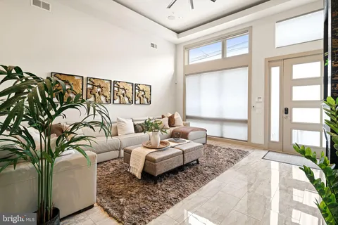 a bedroom with furniture and a large window