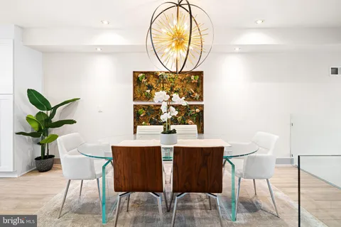 a view of a dining room with furniture and a potted plant