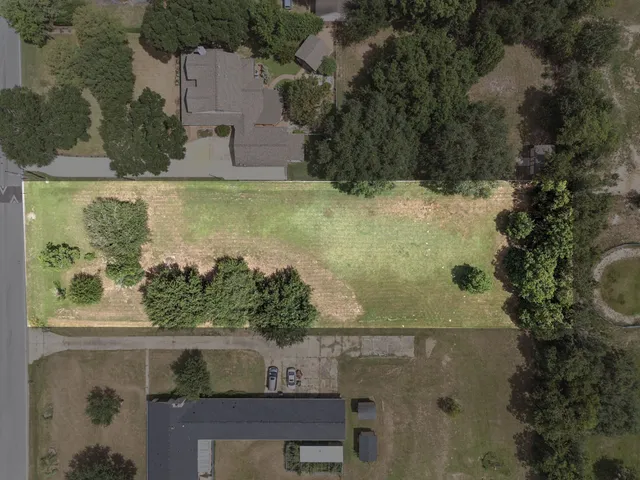 an aerial view of a residential houses with outdoor space