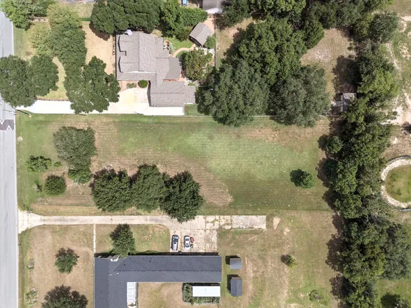 an aerial view of a residential houses with outdoor space