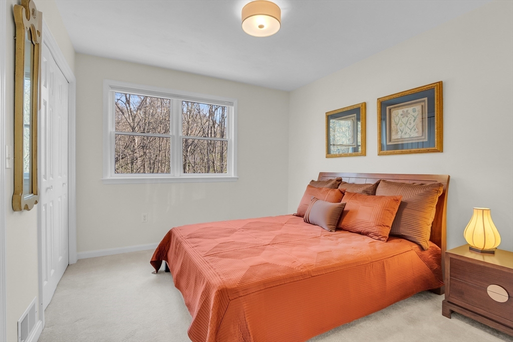 133 Nashaway Road Bolton, MA 01740 - Photo 24 of 42 a bedroom with a bed and painting on the wall