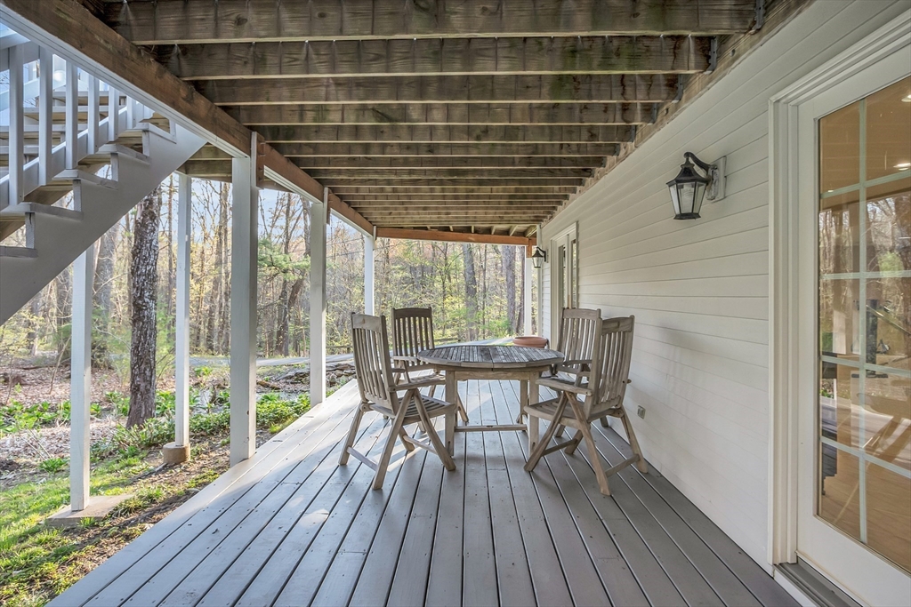133 Nashaway Road Bolton, MA 01740 - Photo 34 of 42 a patio with table and chairs and wooden floor