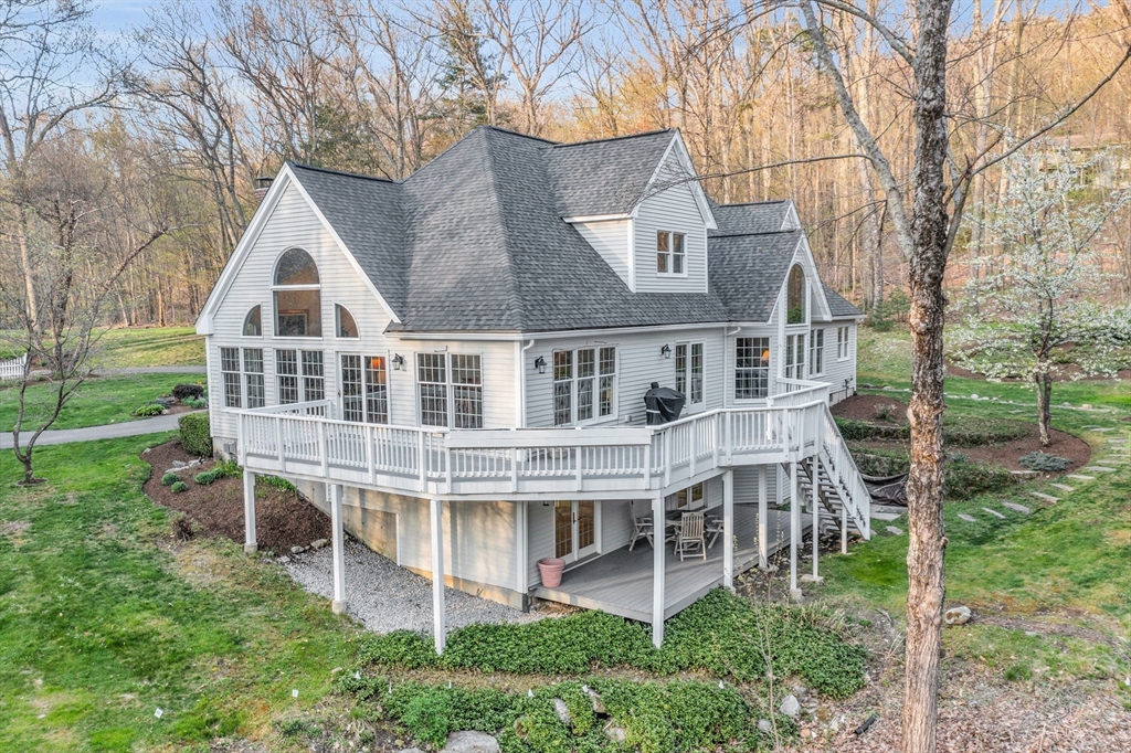 133 Nashaway Road Bolton, MA 01740 - Photo 37 of 42 a house with tall trees in the background