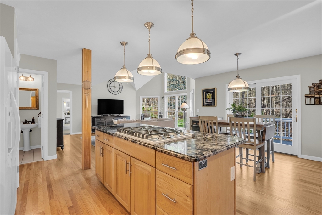 133 Nashaway Road Bolton, MA 01740 - Photo 8 of 42 a large kitchen with a table and chairs in it