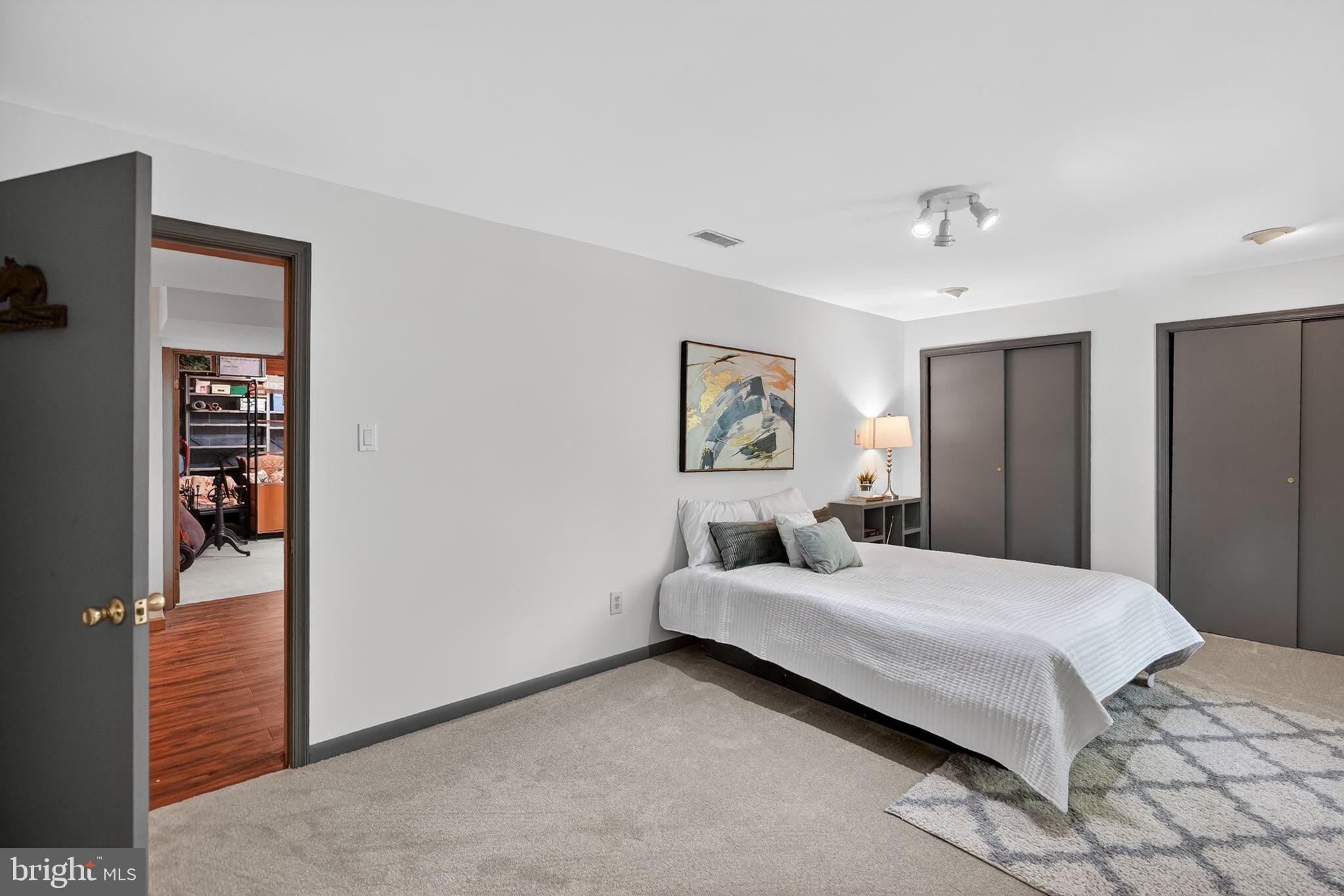 13821 Esworthy Road Darnestown, MD 20874 - Photo 41 of 98 a bedroom with a bed and a painting on the wall