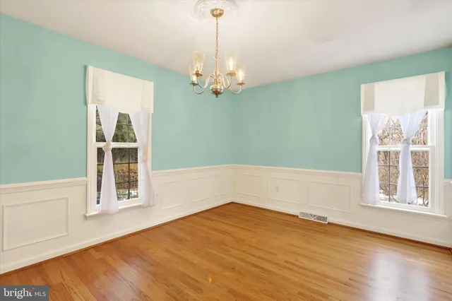 a bedroom with a bed and painting on the wall