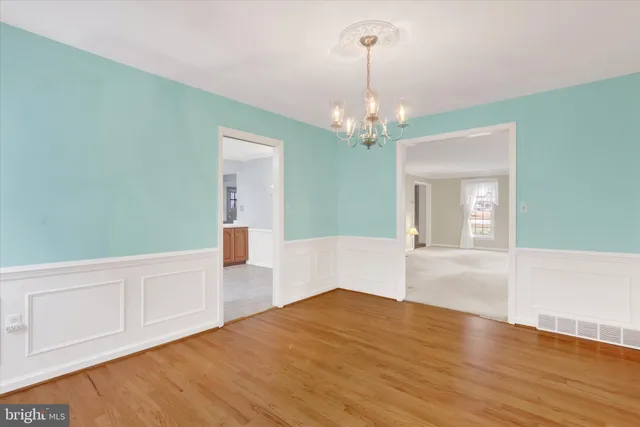 a bedroom with a large bed and windows